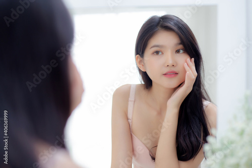 Beautiful young asian woman smiling look at mirror of checking face with skin care and cosmetic for rejuvenation and hygiene, beauty girl happy clean facial with cream or lotion and for health. Free Download Beautiful young asian woman smiling look at mirror of checking face with skin care and cosmetic for rejuvenation and hygiene, beauty girl happy clean facial with cream or lotion and for health. - GFXLoad