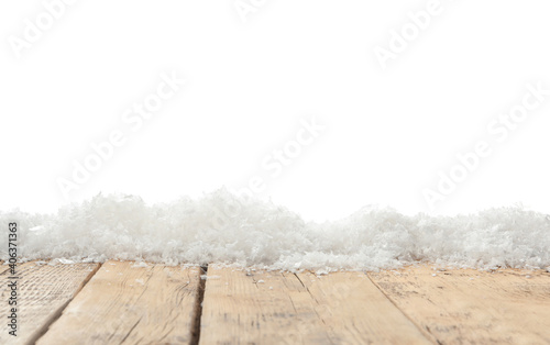 Snow on wooden surface against white background. Christmas season