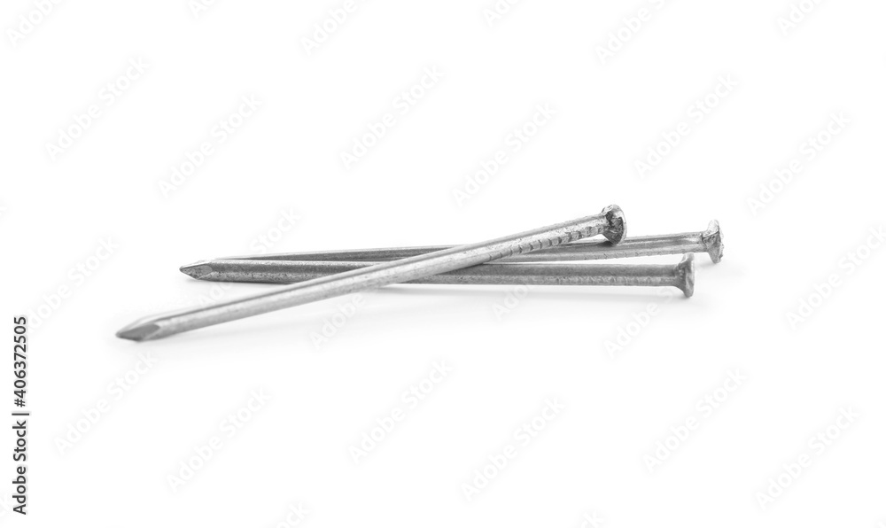 Sharp shiny metal nails on white background Sharp shiny metal nails on white background