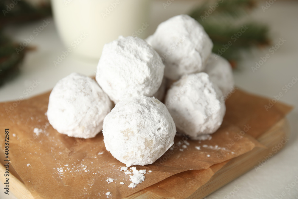 Tasty Christmas snowball cookies on light table, closeup