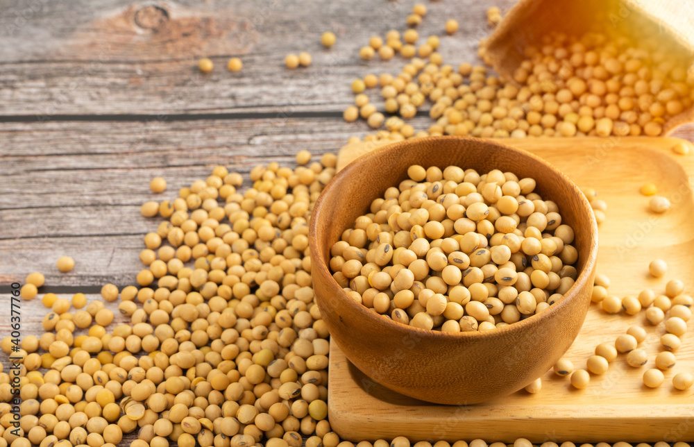 Soybeans in brown wooden bowl on wooden table background.Healthy food Concept. Soybeans in brown wooden bowl on wooden table background.Healthy food Concept.