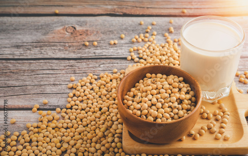 Soybeans in brown wooden bowl with Soy milk on wooden table background.Healthy food Concept.