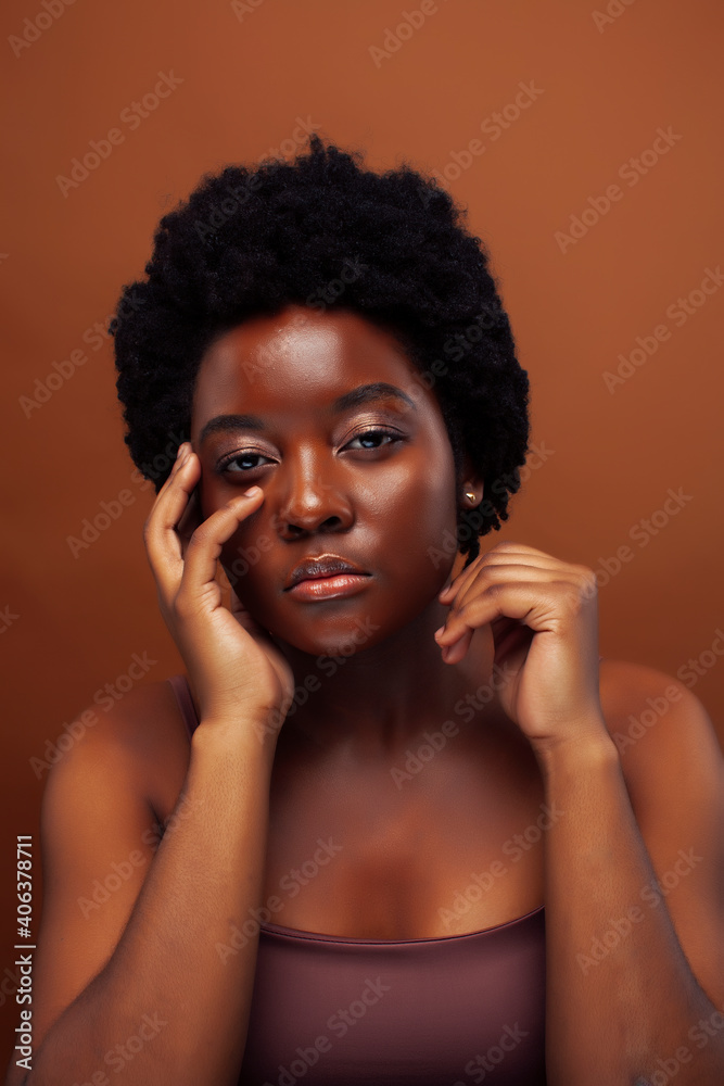 young pretty african model smiling happy on brown background, lifestyle people concept young pretty african model smiling happy on brown background, lifestyle people concept