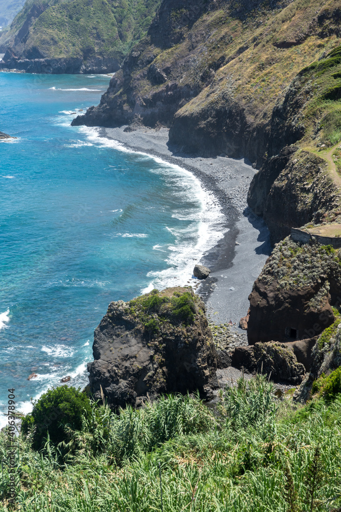 Stoney beach with high cliffs on Madeira Island