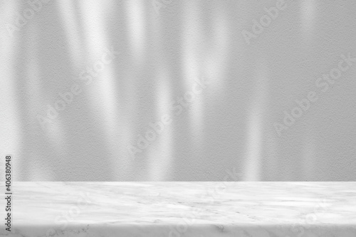 White Marble Table with Tree Shadow on Concrete Wall Texture Background, Suitable for Product Presentation Backdrop, Display, and Mock up. © mesamong