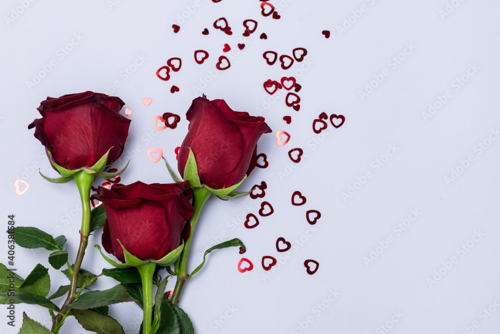 Red Roses Red Flower on Light Blue Background Red Confetti in Shape of Hearts Holidey Background Valentine's Day Red Roses Red Flower on Light Blue Background Red Confetti in Shape of Hearts Holidey Background Valentine's Day