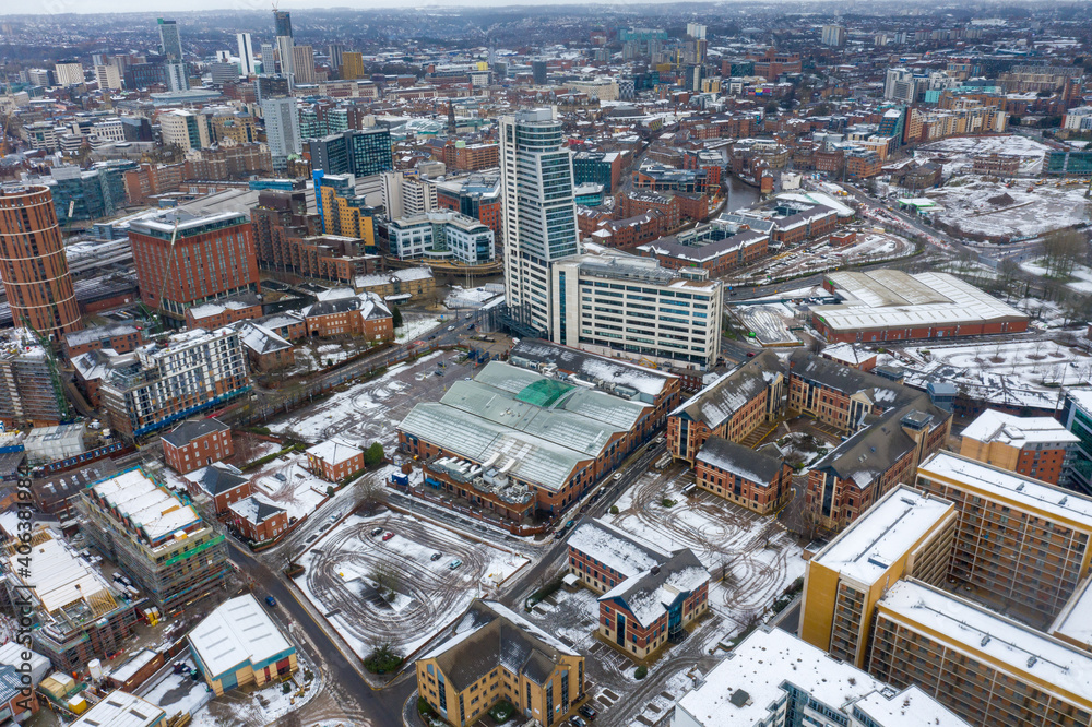 Fototapeta premium Aerial photo of the town centre of Leeds in West Yorkshire, near the Bridgewater Place apartment building along side the Leeds Train Station in the snow and winter time
