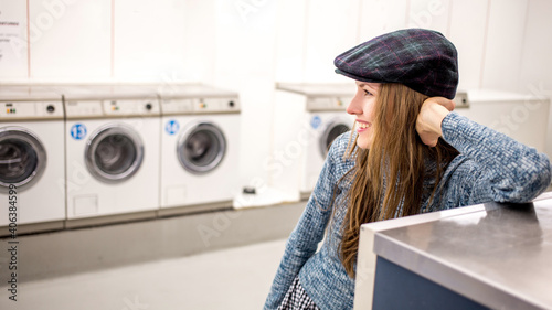 Young woman in a public european laundry  photo