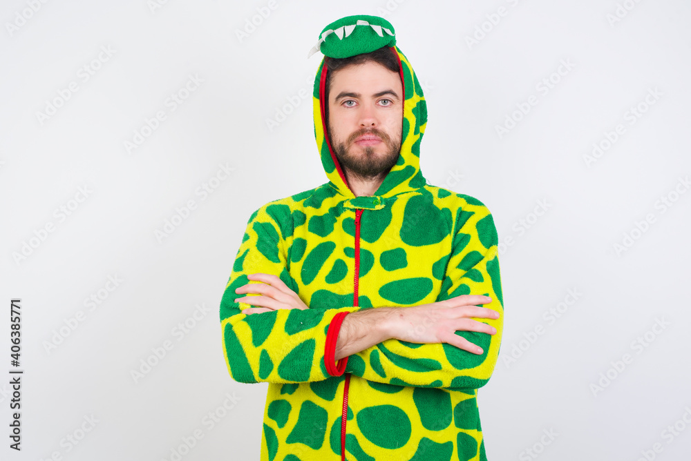 Serious pensive Young caucasian man wearing a pajama standing against white background feel like cool confident entrepreneur cross hands. Serious pensive Young caucasian man wearing a pajama standing against white background feel like cool confident entrepreneur cross hands.