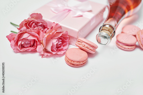 Macaroon sweets and bottle of champagne. Romantic breakfast and dinner.. Valentine's day greeting card. Flowers and gifts boxes on white background. Happy birthday and mother's day template.