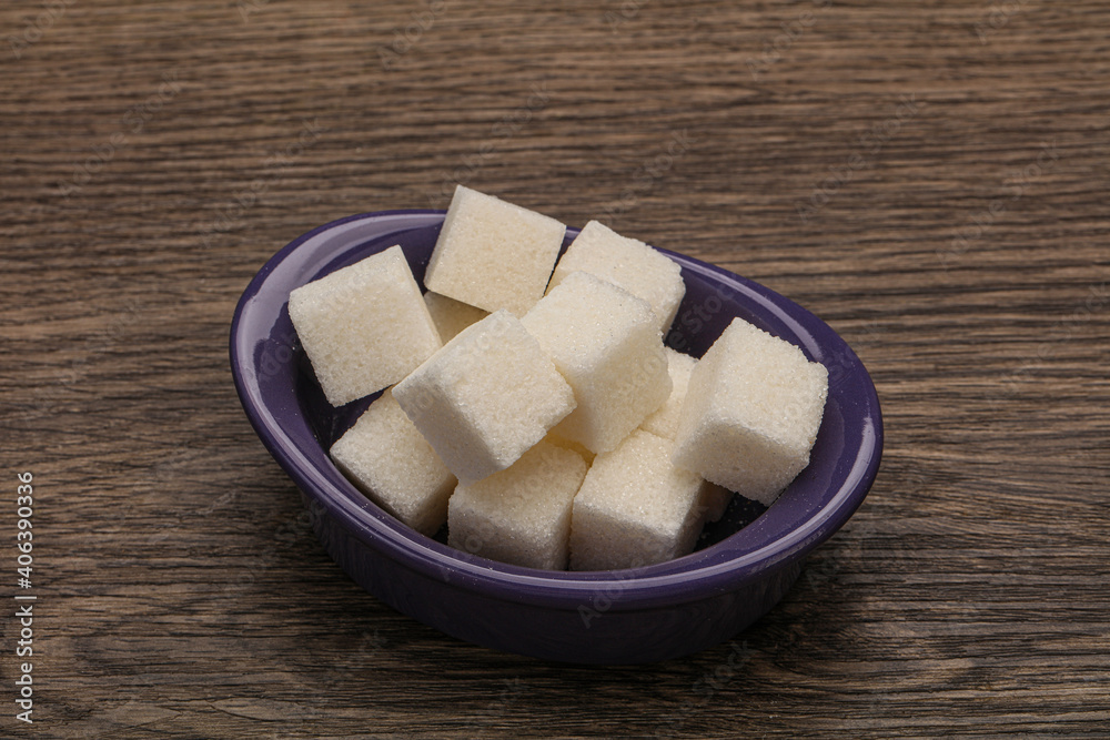 Refined white sugar cubs in the bowl Refined white sugar cubs in the bowl