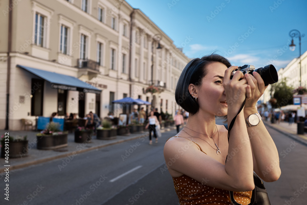 Female tourist shooting on the street, summer Eurotrip