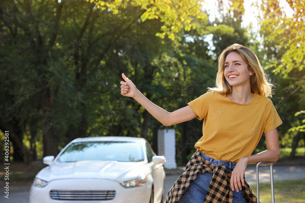 Young woman hitchhiking taxi on city street Young woman hitchhiking taxi on city street