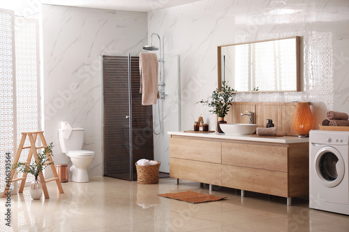 Modern bathroom interior with stylish mirror and vessel sink