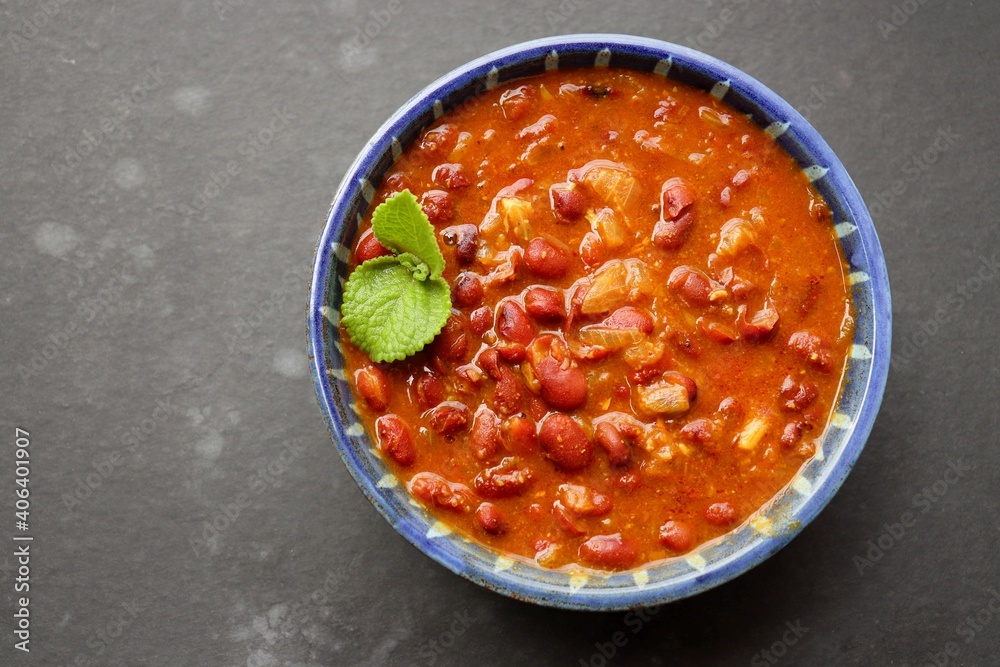 Rajma curry is a popular North Indian Food. Rajma is a socked Red kidney beans cooked with onions, tomatoes and a special blend of spices. Served with Jeera rice or Cumin Rice. With Copy Space. Rajma curry is a popular North Indian Food. Rajma is a socked Red kidney beans cooked with onions, tomatoes and a special blend of spices. Served with Jeera rice or Cumin Rice. With Copy Space.
