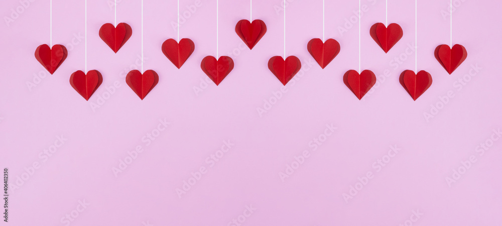 Valentine's Day love wedding background banner panorama greeting card template - Red hanging hearts isolated on pink paper texture