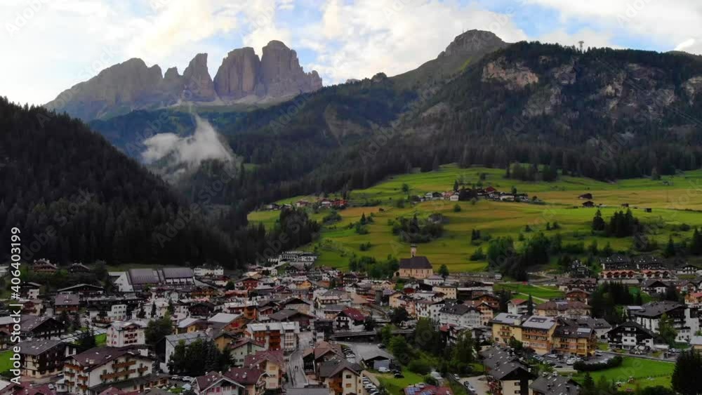 Aerial Scenic view of Cortina d' Ampezzo surrounded by majestic mountains . Dolomites Mountains. Rocky mountains in the shadow. Italian Dolomites valley. Drone Footage over the mountain peak Aerial Scenic view of Cortina d' Ampezzo surrounded by majestic mountains . Dolomites Mountains. Rocky mountains in the shadow. Italian Dolomites valley. Drone Footage over the mountain peak