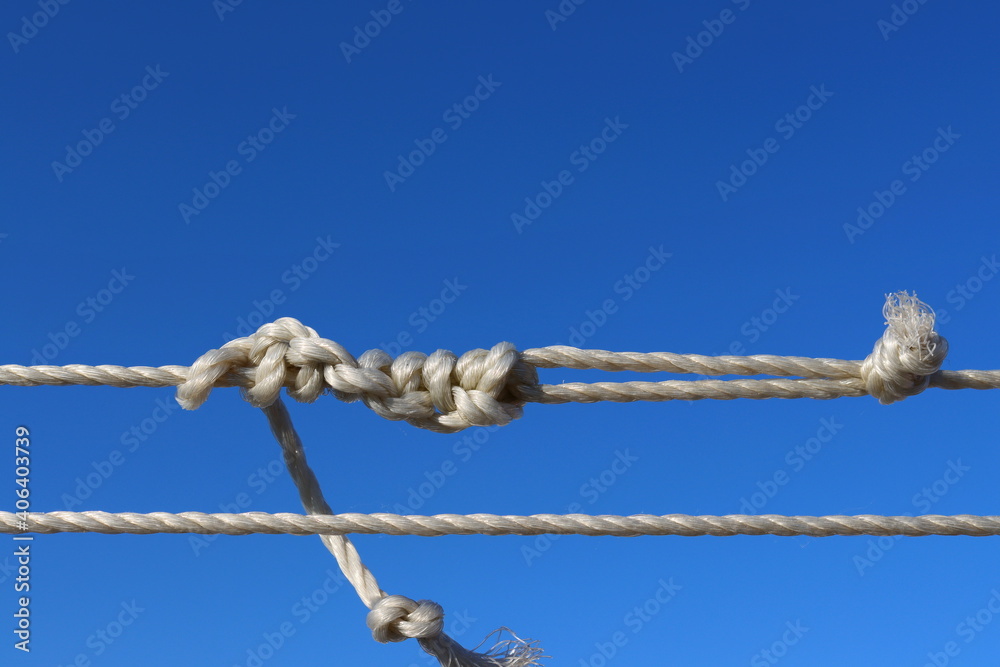 White rope with knots on a blue background