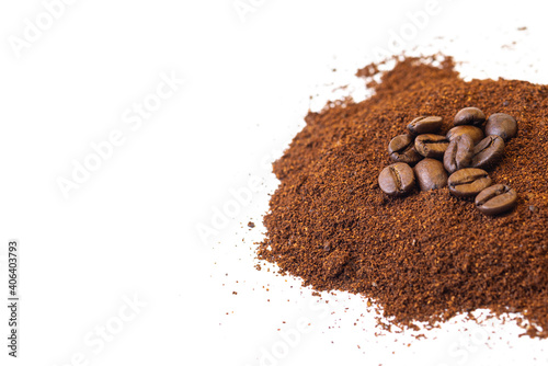 Roasted coffee beans at the top of a pile of ground coffee on an isolated white background. With white area for copy space text.