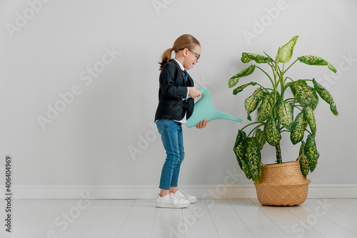 Kid is watering plant