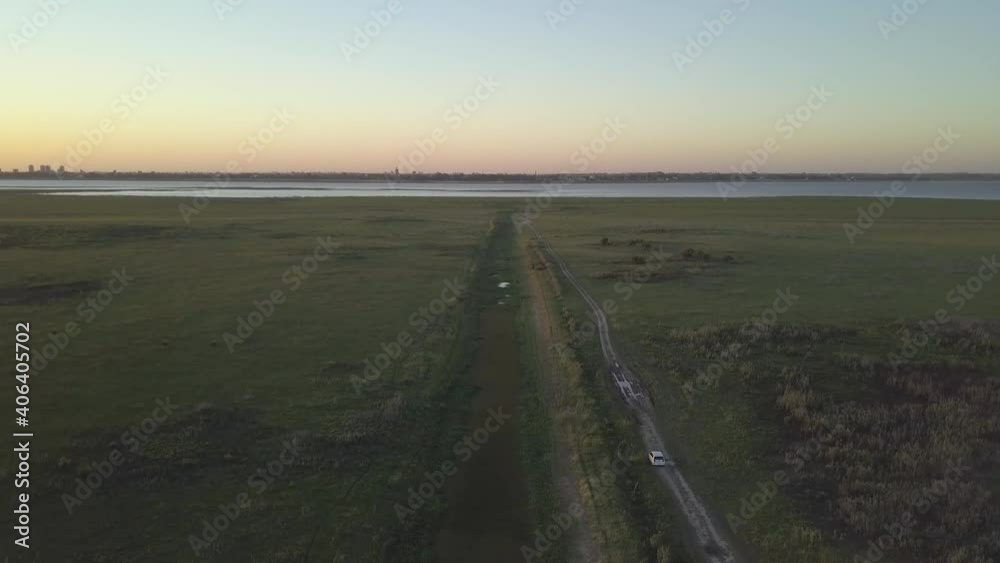 Aerial ascending view of Laguna Setubal with the skyline of Santa Fe in Argentina during the sunset Aerial ascending view of Laguna Setubal with the skyline of Santa Fe in Argentina during the sunset