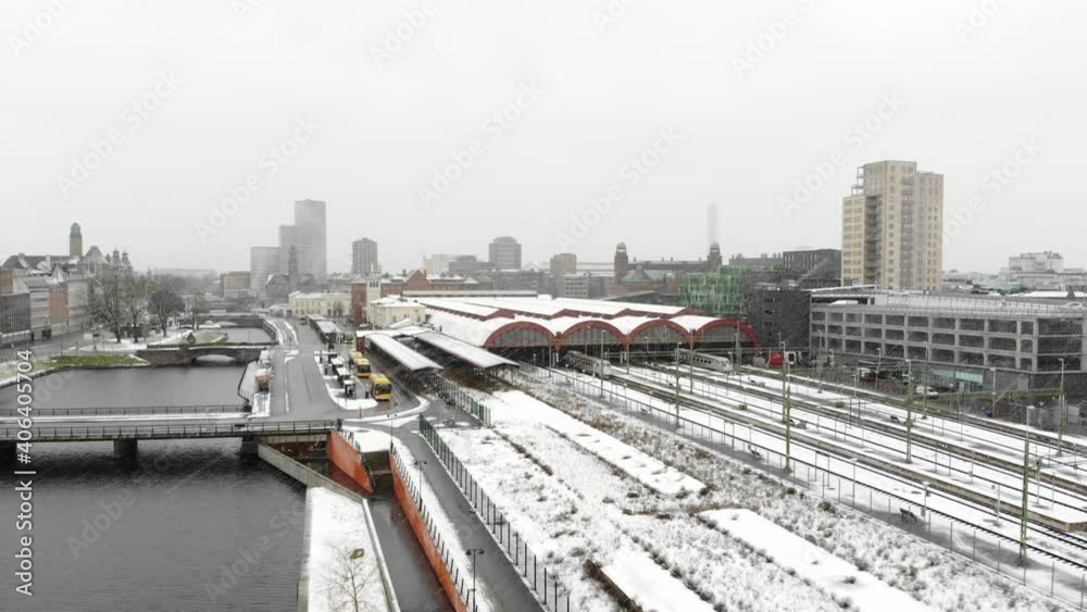 Drone flying towards Malmö Central Station in snow. Turning torso, Clarion Hotel in background Drone flying towards Malmö Central Station in snow. Turning torso, Clarion Hotel in background