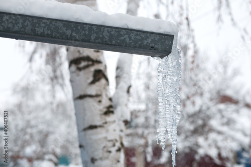 Icicle. Dangerous in winter. Icicle on the drain. Space for text.