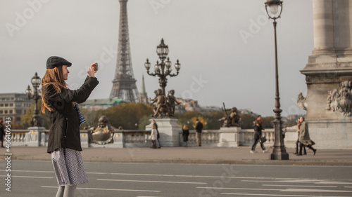 Young traveler taking photos in parisian street, paris, France