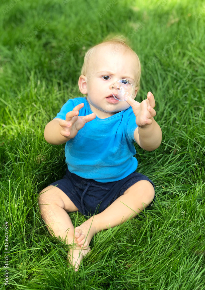 The child catches soap bubbles. Selective focus. The child catches soap bubbles. Selective focus.
