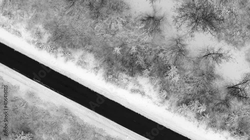 Look up drone shot from a empty street framed by a winter landscape up to snow covered houses of a little idyllic town, calm moment in times of the pandemie. photo