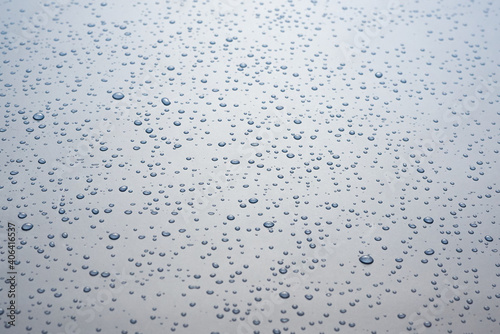 Small drops of water on a gray background.