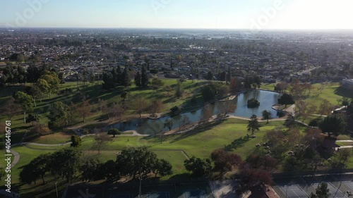 Drone shot flying over the lake at the La Mirada Regional Park. photo