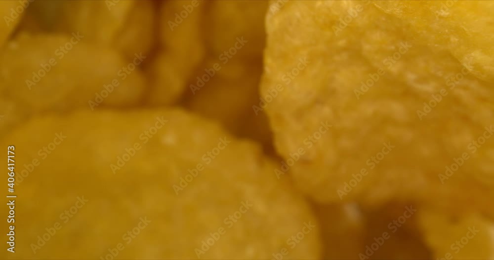 Corn chips or corn crisps, close up. Golden corn flakes. Footage of the morning breakfast. High quality. Corn chips or corn crisps, close up. Golden corn flakes. Footage of the morning breakfast. High quality.