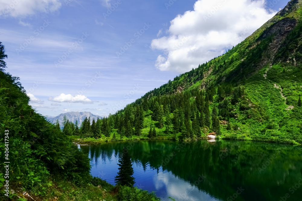 wonderful mountain lake with waves in a green landscape