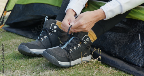 Woman wear sport shoes at camping site
