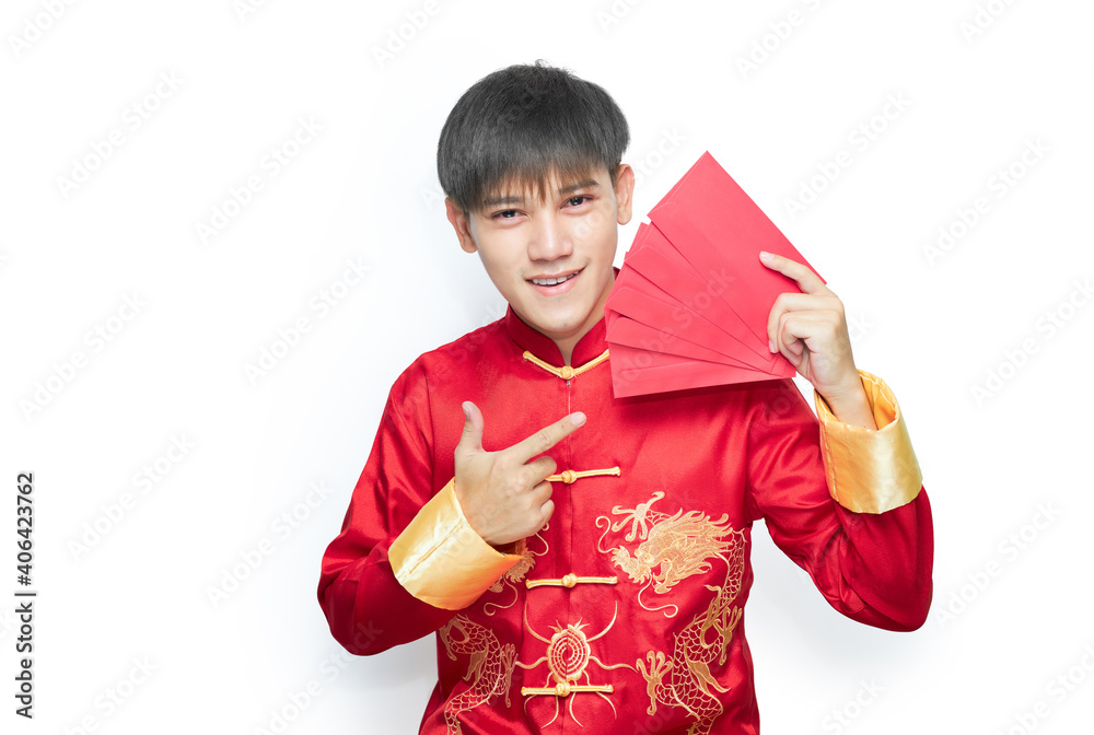 Young Asian man in mandarin collar dress holding red envelope packet on white background with clipping path. Chinese new year concept. Young Asian man in mandarin collar dress holding red envelope packet on white background with clipping path. Chinese new year concept.