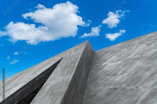 Exterior building gray cement wall and blue sky white clouds background 