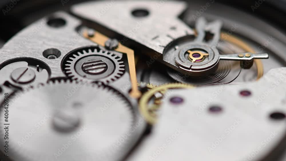 Internal working mechanism of the wristwatch with a rapidly rotating pendulum and gears. 4k clock close up with shallow depth of field Internal working mechanism of the wristwatch with a rapidly rotating pendulum and gears. 4k clock close up with shallow depth of field