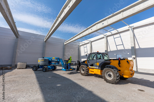 Warehouse construction with industrial vehicles. photo