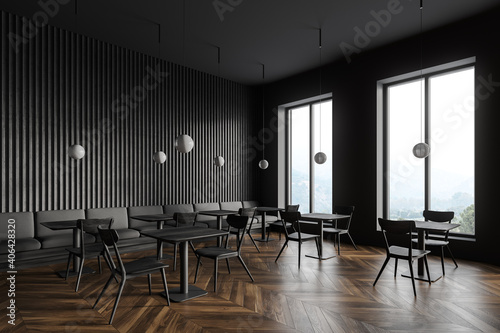 Dark gray restaurant corner with tables and sofa