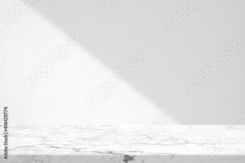 Marble Table with White Stucco Wall Texture Background with Light Beam and Shadow, Suitable for Product Presentation Backdrop, Display, and Mock up.