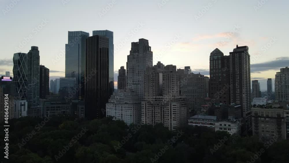 Drone rising over amazing Midtown Manhattan skyline with supertall skyscrapers taken from Central Park South during sunset in New York City, USA. Drone rising over amazing Midtown Manhattan skyline with supertall skyscrapers taken from Central Park South during sunset in New York City, USA.