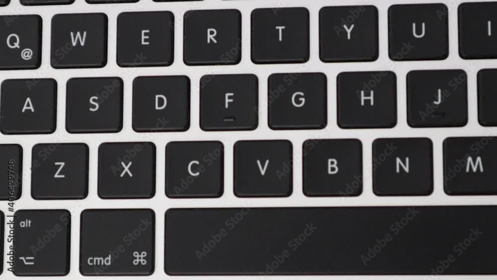 Pressing keys on a laptop keyboard - Close up Pressing keys on a laptop keyboard - Close up