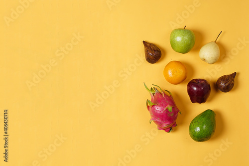 Combination of leaves and fresh fruits. Simple and elegant framing of fruit and leaves. Wallpaper that attracts the eye  commonly used for design templates  mockups and invitations. Jungle Fruits.