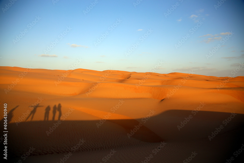 Shadows of people projected on the dunes by the light of the sunset, Wahiba Sands / Sharqiya Sands, Oman Shadows of people projected on the dunes by the light of the sunset, Wahiba Sands / Sharqiya Sands, Oman