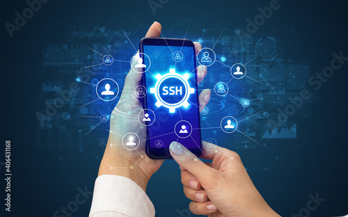 Female hand holding smartphone with SSH abbreviation, modern technology concept