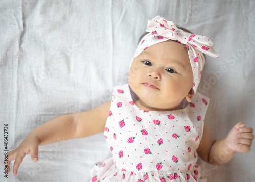 4 Month Old Baby Girl Laying On her Back Looking Up with multiple expressions