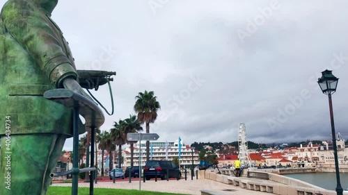 Statue Of Portuguese King Dom Carlos I In The Seaside Town Of Cascais In Portugal. Tilt Down Shot Revealing Cascais Bay, panning photo