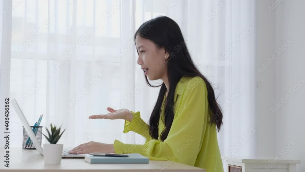Young asian business woman using laptop computer for video conference online with social distancing, businesswoman working with video call, new normal, communication and work from home concept. Young asian business woman using laptop computer for video conference online with social distancing, businesswoman working with video call, new normal, communication and work from home concept.