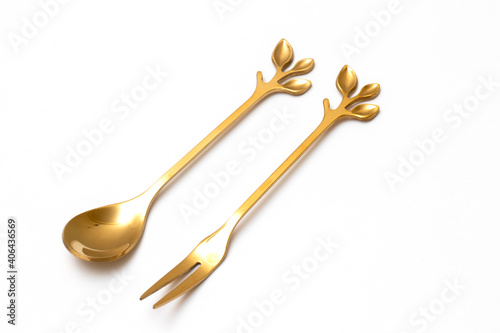 Top view of golden spoon and fork isolated white background.